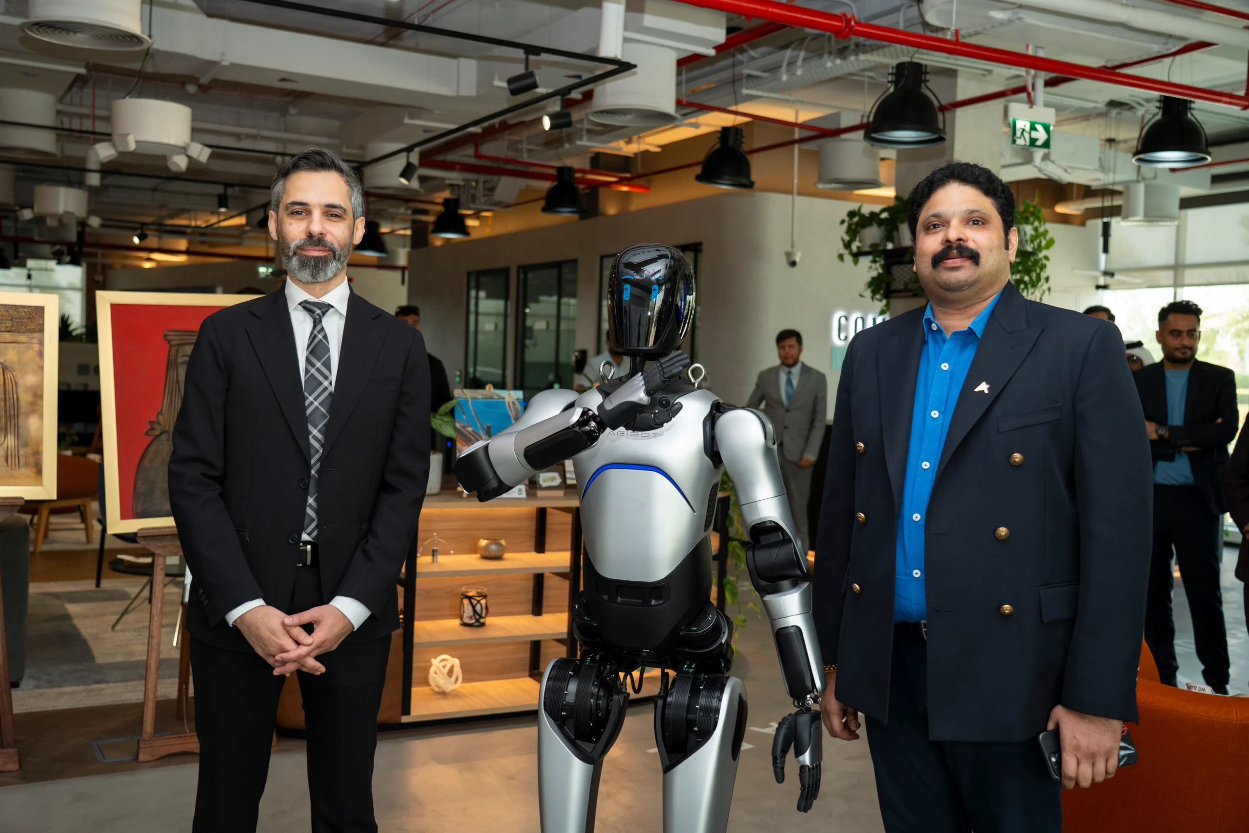 Leaders alongside an AI humanoid robot at the partnership ceremony